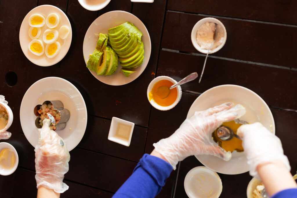 People preparing food during a cooking class in Lima