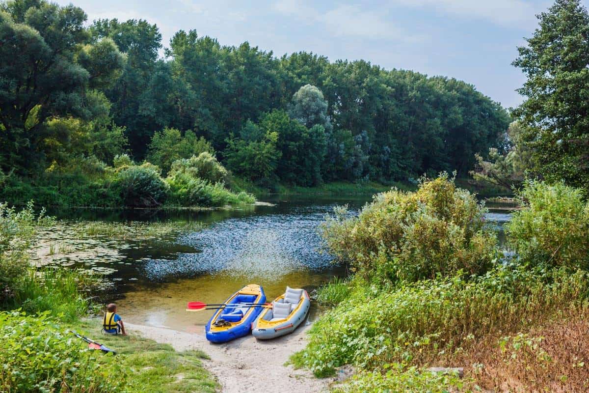 inflatable kayaks and paddle boards, boy at the river, kayaking on the lake inflatable kayaks and paddle boards, boy at the river, kayaking on the lake