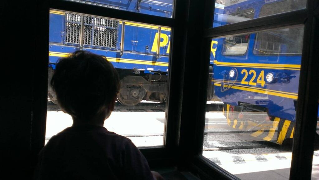 Cafe Mayu Ollantaytambo Peru boy watching train to Machu Picchu