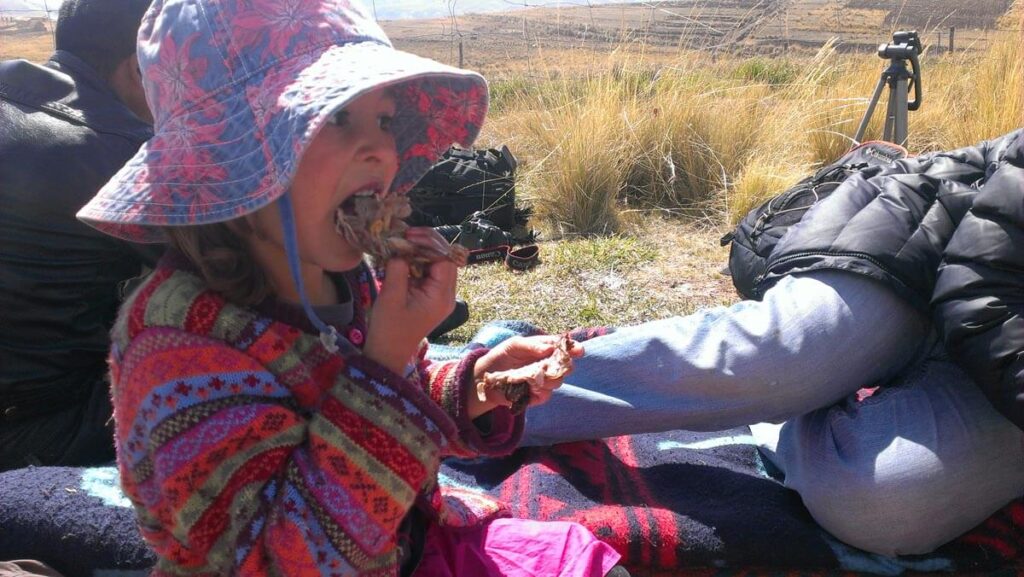 kid eating food in peru