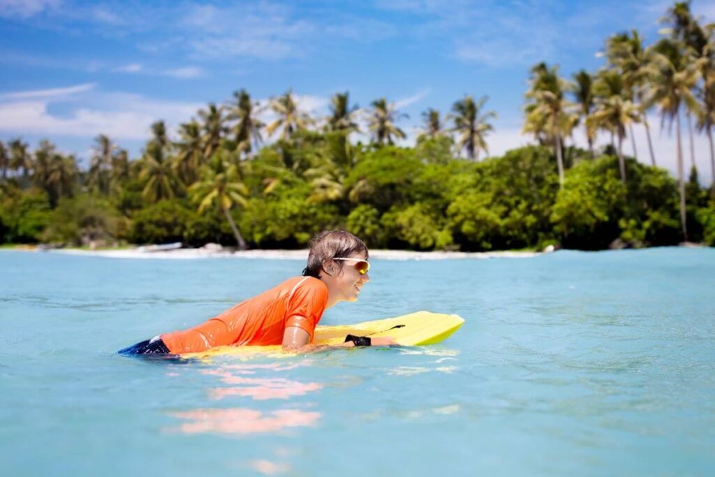 kids rashie, thermal rash guard, body boarding, child playing at the beach kids rashie, thermal rash guard, body boarding, child playing at the beach