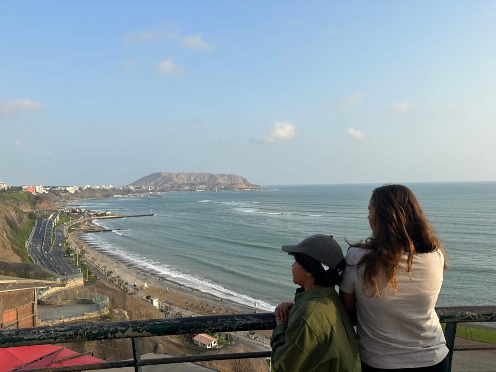 two kids looking at the beach of Lima, Peru