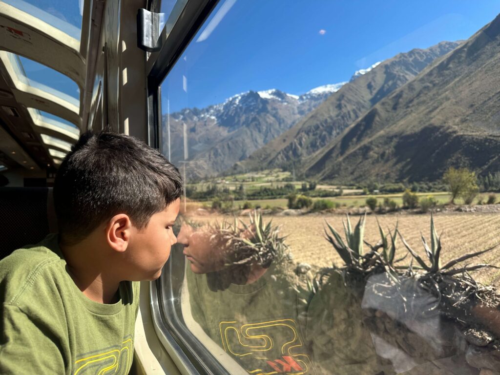 kid taking the train to machu picchu