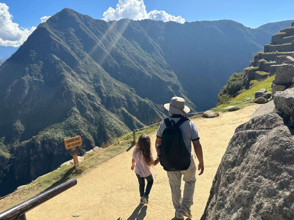 guide with little girl at machu picchu site