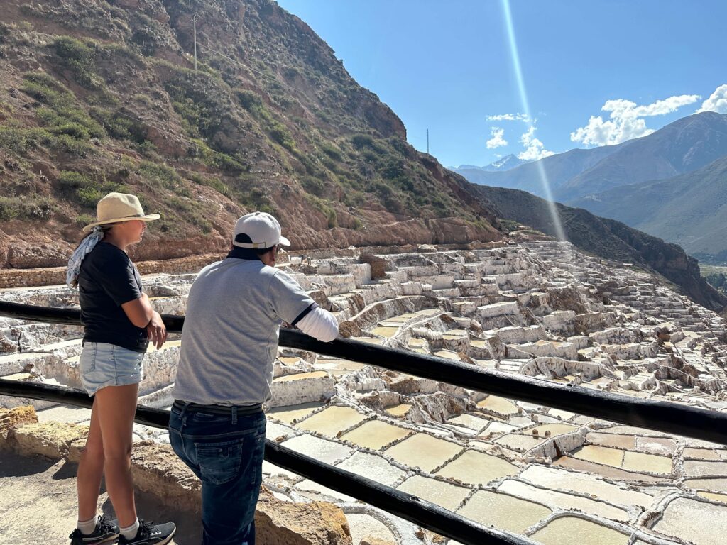 people standing at maras site and enjoying the view